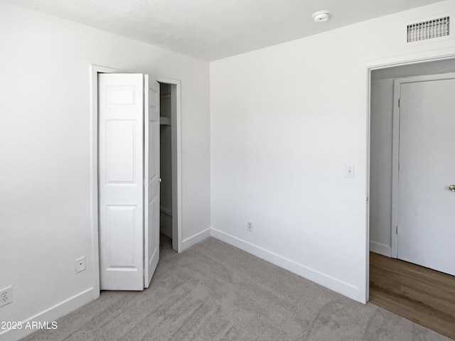 5308 N 77th Dr, Glendale, AZ 85303 - unfurnished bedroom with baseboards, carpet flooring, and visible vents