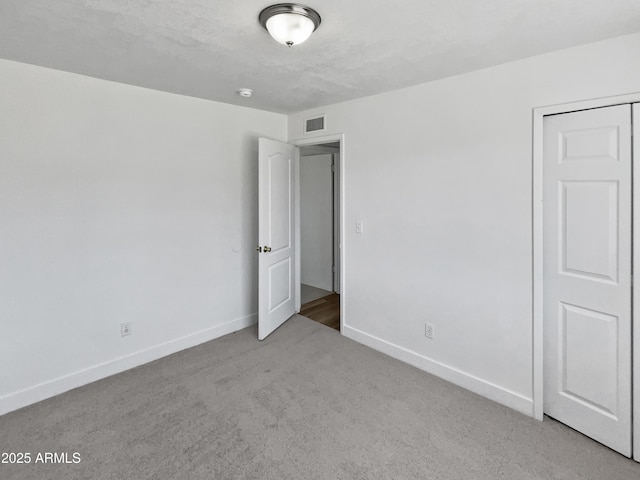 5308 N 77th Dr, Glendale, AZ 85303 - unfurnished bedroom with baseboards, carpet flooring, and visible vents