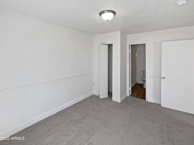 5308 N 77th Dr, Glendale, AZ 85303 - unfurnished bedroom featuring baseboards, a closet, ensuite bathroom, and carpet