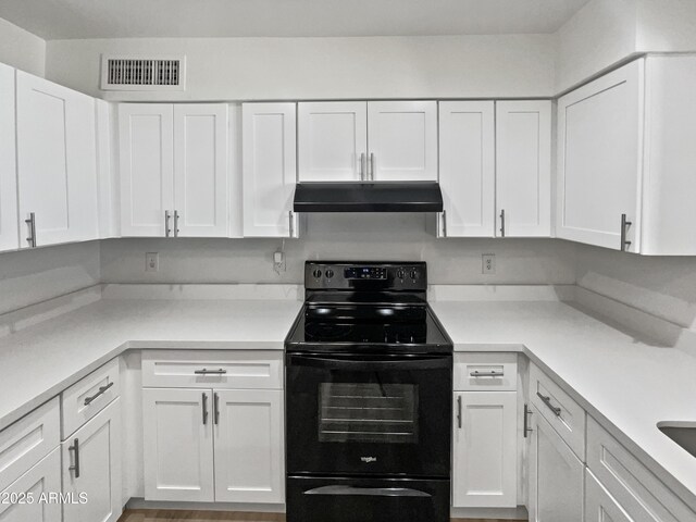 5308 N 77th Dr, Glendale, AZ 85303 - kitchen with visible vents, under cabinet range hood, white cabinetry, and electric range