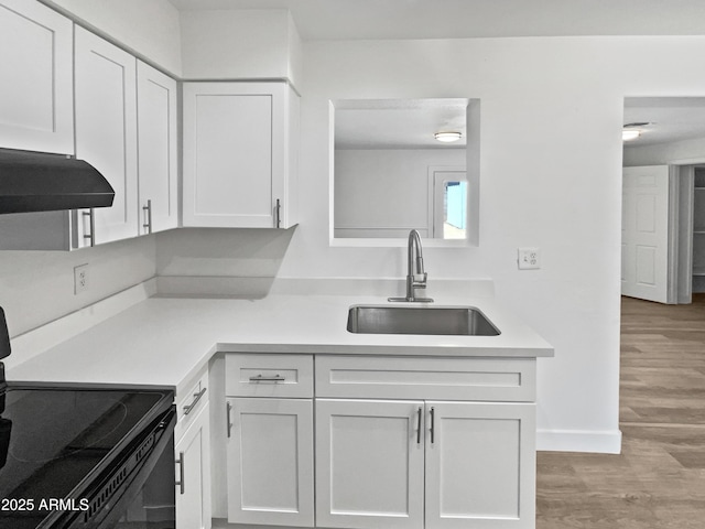 5308 N 77th Dr, Glendale, AZ 85303 - kitchen featuring a sink, light wood-style floors, light countertops, electric range, and white cabinets