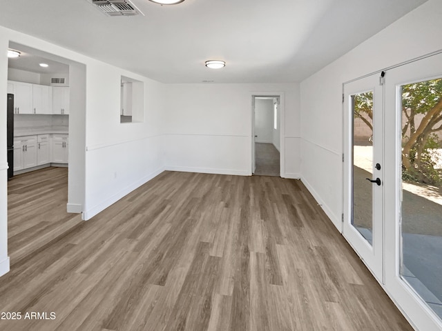 5308 N 77th Dr, Glendale, AZ 85303 - unfurnished room featuring baseboards, french doors, visible vents, and light wood-style flooring