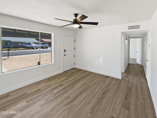 5308 N 77th Dr, Glendale, AZ 85303 - spare room with baseboards, a ceiling fan, wood finished floors, and visible vents