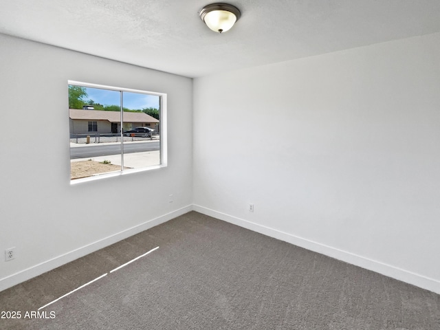 5308 N 77th Dr, Glendale, AZ 85303 - spare room with dark carpet and baseboards