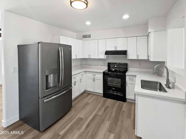 5308 N 77th Dr, Glendale, AZ 85303 - kitchen with stainless steel fridge, a sink, visible vents, black electric range oven, and under cabinet range hood