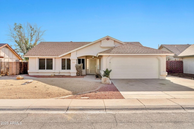 11154 W Ashley Chantil Dr, Surprise, AZ 85378 - view of front of home featuring a garage, fence, stucco siding, driveway, and a shingled roof