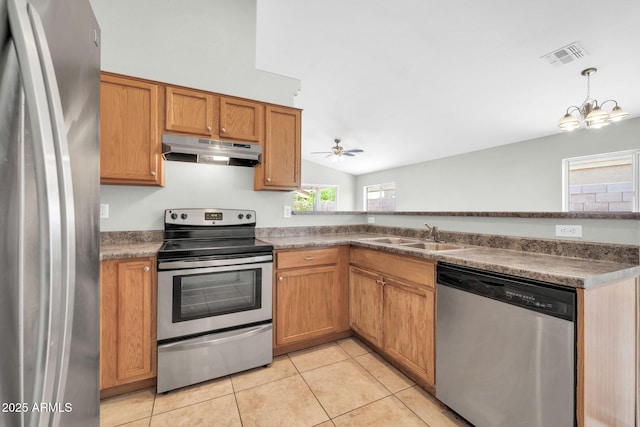 11154 W Ashley Chantil Dr, Surprise, AZ 85378 - kitchen featuring stainless steel appliances, under cabinet range hood, a sink, light tile patterned flooring, and a chandelier