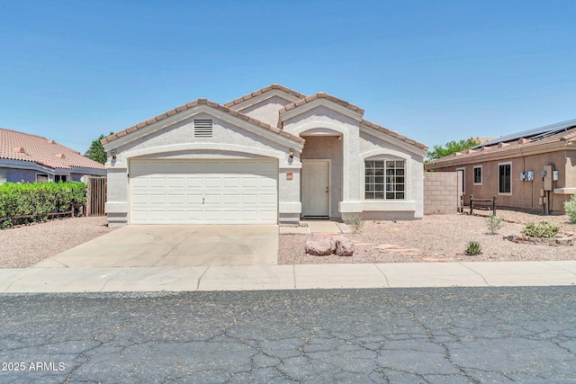 11154 W Ashley Chantil Dr, Surprise, AZ 85378 - mediterranean / spanish house featuring an attached garage, concrete driveway, a tiled roof, and stucco siding