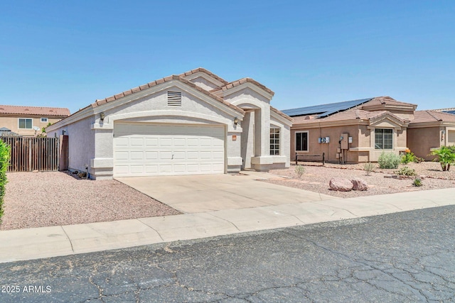 11154 W Ashley Chantil Dr, Surprise, AZ 85378 - view of front of house with an attached garage, concrete driveway, a tile roof, stucco siding, and fence
