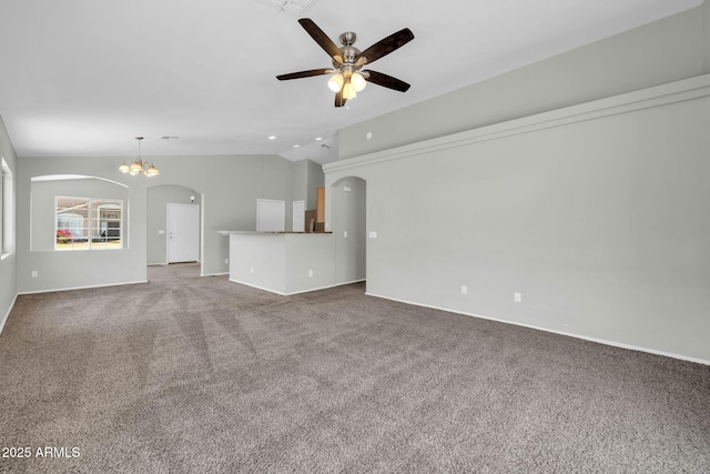11154 W Ashley Chantil Dr, Surprise, AZ 85378 - unfurnished living room featuring arched walkways, vaulted ceiling, ceiling fan, carpet flooring, and baseboards