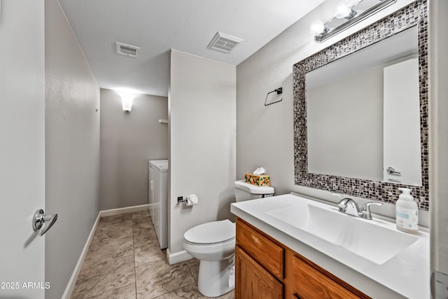 bathroom featuring vanity, washer / dryer, decorative backsplash, and toilet