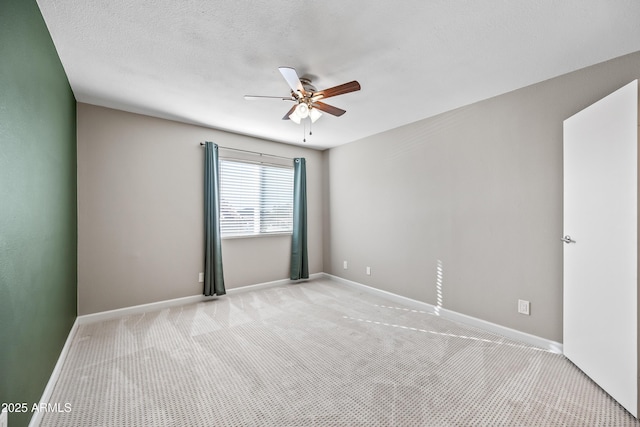 unfurnished room with ceiling fan and light carpet