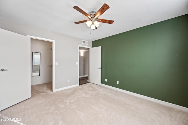 unfurnished bedroom with light carpet and ceiling fan