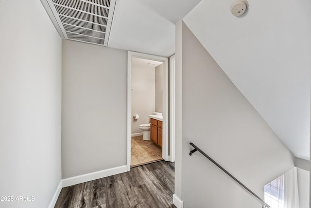 stairs featuring hardwood / wood-style flooring