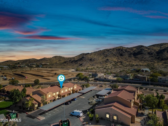 aerial view at dusk featuring a mountain view