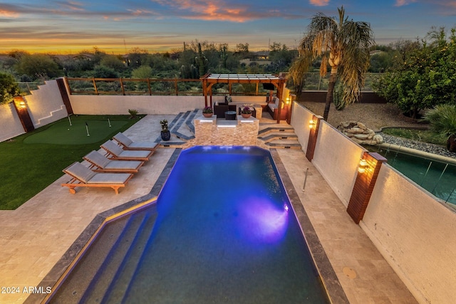 pool at dusk with a patio