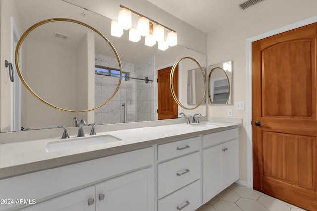 bathroom featuring vanity, a tile shower, and tile patterned floors