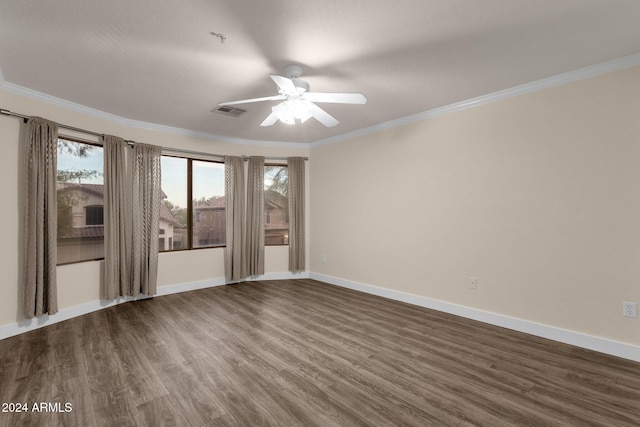 empty room featuring crown molding, ceiling fan, and dark wood-type flooring