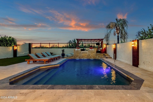 pool at dusk with a patio area