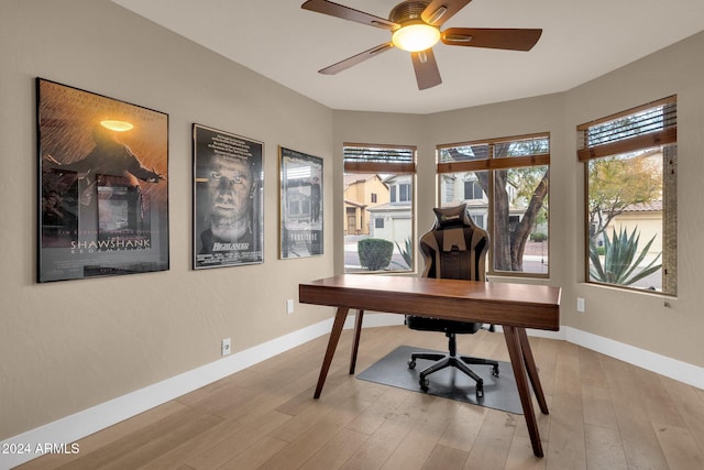 office area with light hardwood / wood-style flooring, ceiling fan, and a healthy amount of sunlight