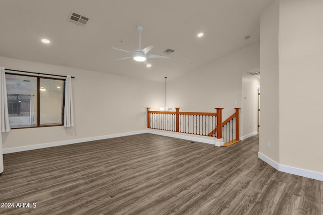 spare room featuring ceiling fan, lofted ceiling, and dark wood-type flooring