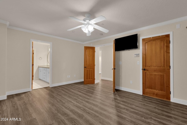 unfurnished bedroom with ornamental molding, ensuite bath, dark wood-type flooring, and ceiling fan