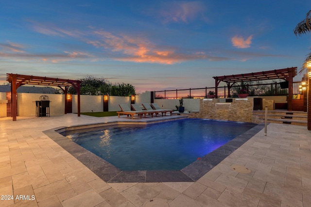 pool at dusk with a pergola and a patio