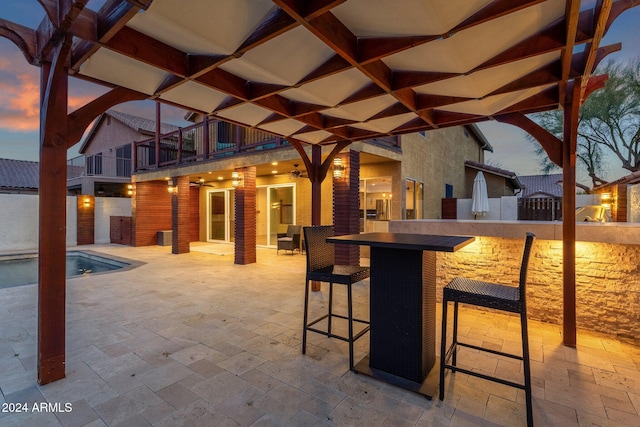 patio terrace at dusk with exterior bar