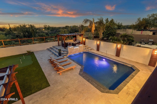 pool at dusk with a patio area