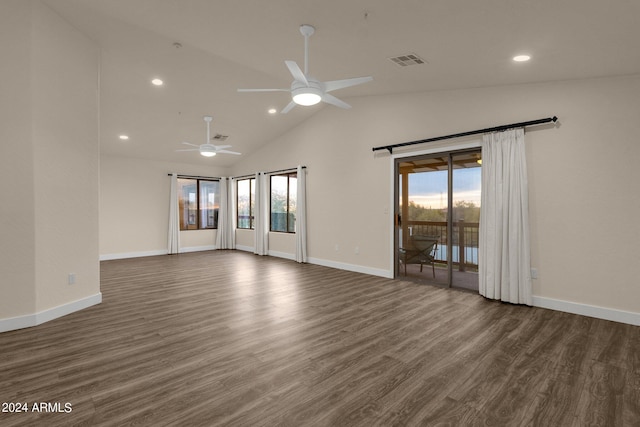 empty room with lofted ceiling, ceiling fan, and dark wood-type flooring