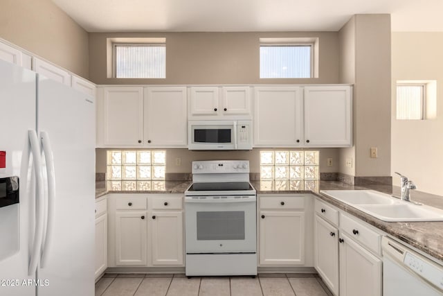 kitchen with white cabinetry, white appliances, a wealth of natural light, and a sink