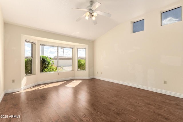 unfurnished room featuring ceiling fan, dark wood-type flooring, baseboards, and vaulted ceiling