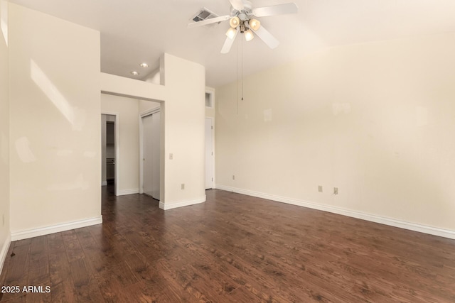 empty room with baseboards, a ceiling fan, lofted ceiling, and dark wood-style flooring