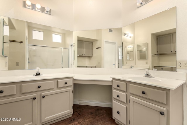 full bathroom featuring visible vents, an enclosed shower, wood finished floors, and vanity