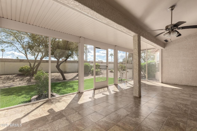 unfurnished sunroom with a ceiling fan