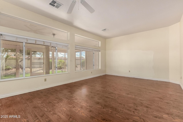 empty room with visible vents, baseboards, a ceiling fan, and wood finished floors