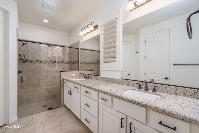 bathroom featuring vanity, tile patterned flooring, and a shower with door