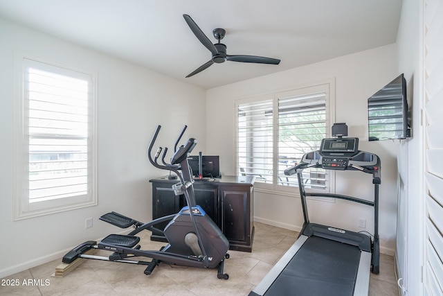 exercise room featuring light tile patterned floors and ceiling fan