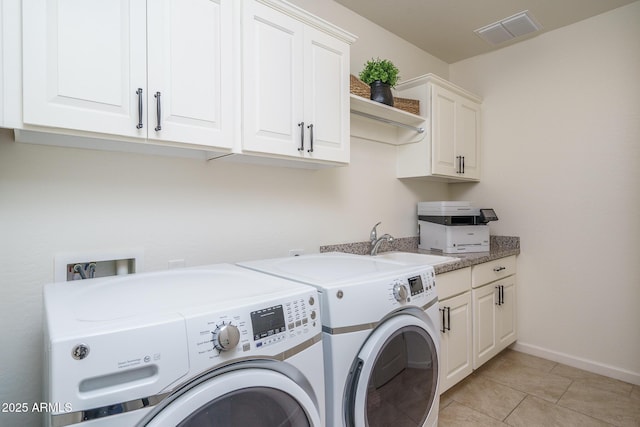 laundry area featuring cabinets, washer and clothes dryer, sink, and light tile patterned floors