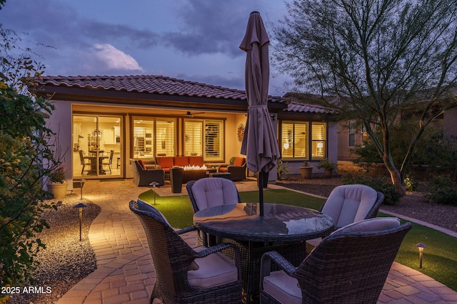 patio terrace at dusk featuring an outdoor living space