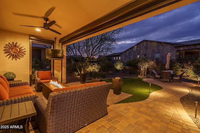 view of patio / terrace featuring an outdoor living space with a fire pit and ceiling fan