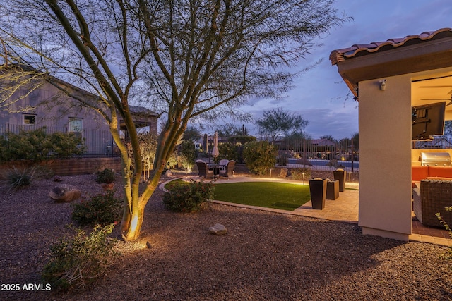 yard at dusk with a patio