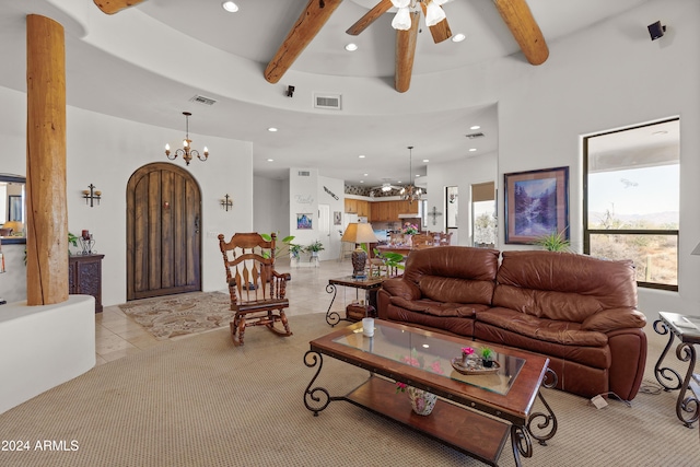 tiled living room with ceiling fan with notable chandelier and beam ceiling