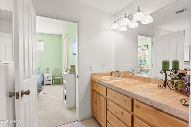 bathroom with a wealth of natural light, water heater, and vanity