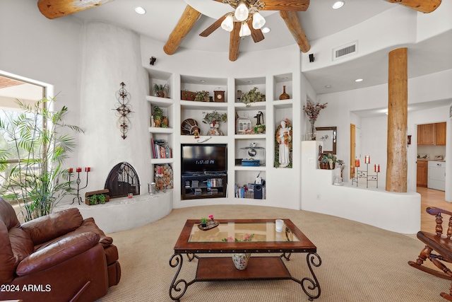 living room featuring ceiling fan and beamed ceiling