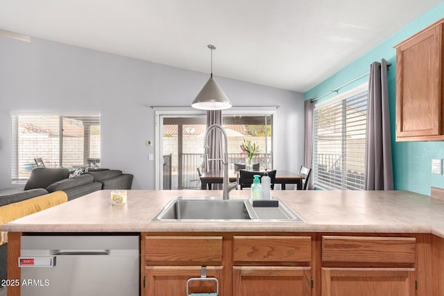 kitchen with stainless steel dishwasher, lofted ceiling, sink, and hanging light fixtures