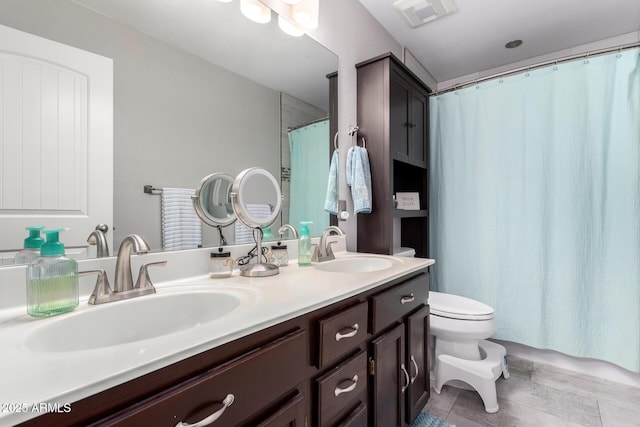 bathroom featuring vanity and toilet