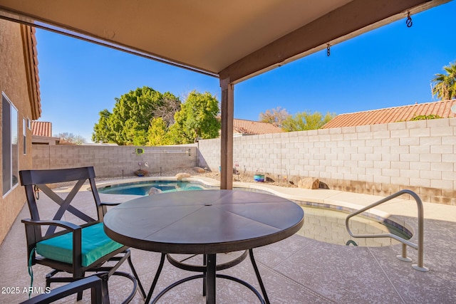 view of patio / terrace with a fenced in pool