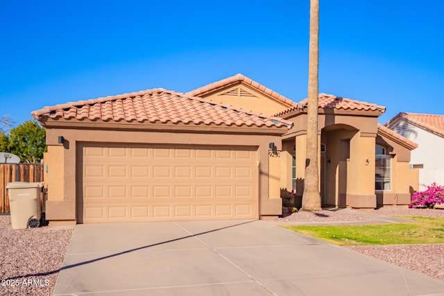 mediterranean / spanish-style home with a garage