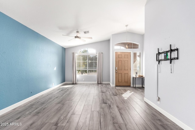 interior space with hardwood / wood-style flooring, lofted ceiling, and ceiling fan